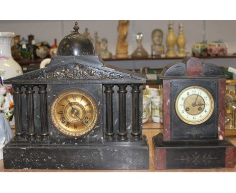 A Victorian black slate mantel clock, of architectural form, having an arched  top surmounted by a dome above a classical fri