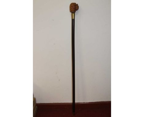 A novelty reproduction walking stick having a hardwood shaft, the head in the form of a dog