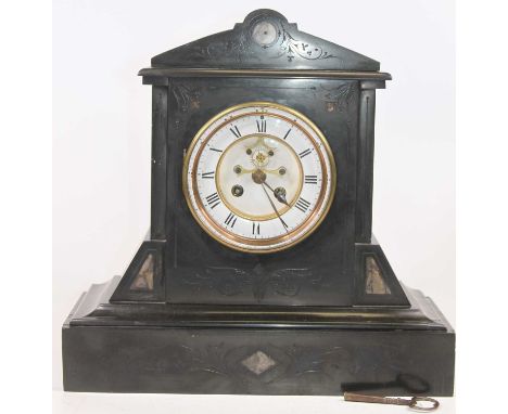 A late Victorian black slate cased mantel clock, having a circular enamelled chapter ring with Roman numerals, visible anchor