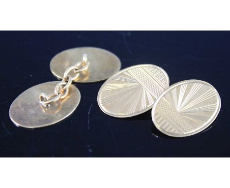A pair of gent's 9ct gold double-ended cufflinks, each of oval form with engine turned decoration; together with a yellow met