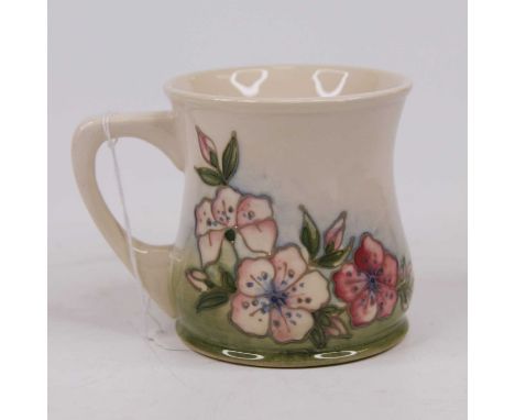 A Moorcroft pottery mug, boxedCrazed in places.Some light scratches.Otherwise in good condition and free from cracks, chips a