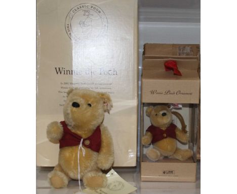 A Steiff Winnie the Pooh soft toy with moving limbs in red waistcoat with button to ear and white label and further tag No. 0