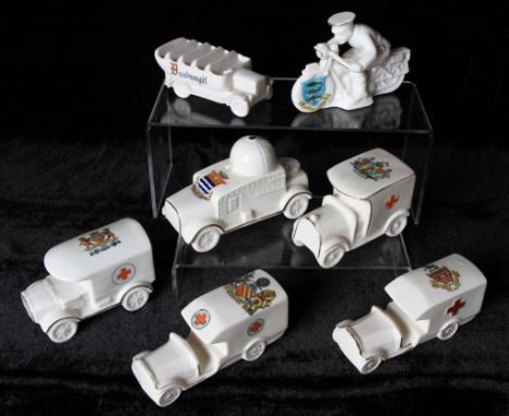 A group of seven WW1 Crested Ware military related vehicle ornaments to include; armoured car with Burton upon Trent crest by