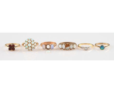 A 9ct yellow gold opal cluster ring, set with nineteen graduated round opal cabochons, with split shoulders, hallmarked Londo