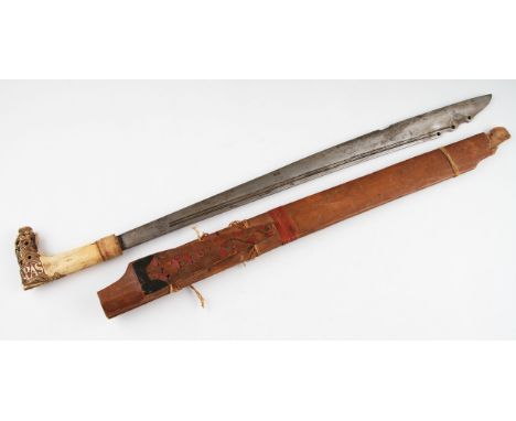 An early 20th Century Parang sword with carved bone handle with an open work foliage design with carved letters Landpas, hand