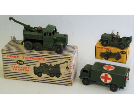 Dinky - three military models comprising Recovery Tractor No. 661 and Austin Champ No. 674, both boxed, and Military Ambulanc