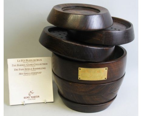 The Remy Martin Cognac Game Collection, comprising a mahogany games compendium in the form of a sectional stacking barrel con