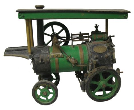 A scratch built live steam model traction engine, the brass and iron body with 9cm diameter canopy, bears two brass plaques i