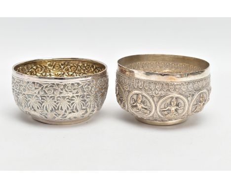 TWO WHITE METAL DISHES, two dishes embossed with south Asian artwork, one dish embossed with deities, approximate diameter 10