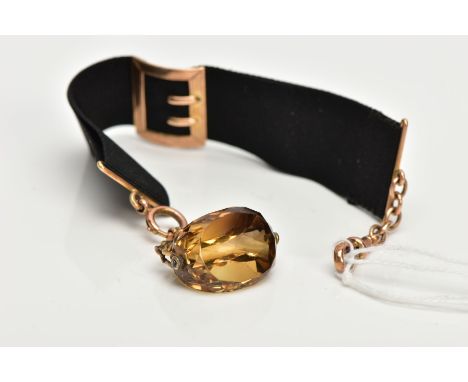 A CITRINE SWIVEL WATCH FOB, faceted citrine within a swivel curb link mount, rubbed 9ct gold hallmark, fitted with a spring c