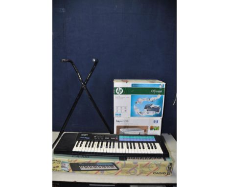 A CASIO CA-100 Tonebank keyboard with stand along with two HP printers one a HP Officejet J4580 and a HP PSC 1205 (all untest