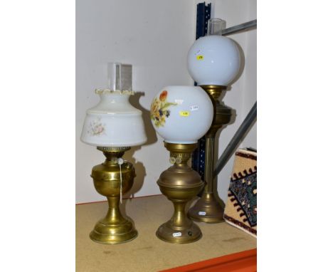 TWO 2OTH CENTURY BRASS BASED OIL LAMPS, A TABLE LAMP IN A SIMILAR STYLE AND TWO TURKISH SYNTHETIC RUG SAMPLES, the taller lam