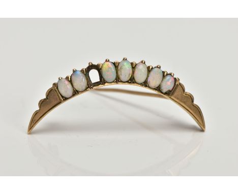 A YELLOW METAL CRESCENT OPAL BROOCH, a yellow metal  brooch set with seven oval opal cabochons (open setting for an eighth op