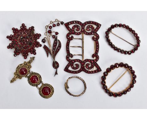 A SELECTION OF BOHEMIAN GARNET BROOCHES AND A BUCKLE, three brooches set with rose cut garnets into a yellow metal mount, one