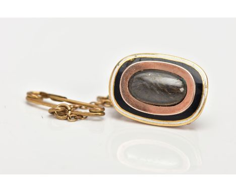 A MID VICTORIAN GOLD AND ENAMEL MEMORIAL BROOCH, of oval outline, the central woven hair panel within a black and white ename