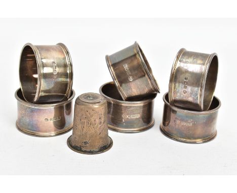 SIX SILVER NAPKIN RINGS AND A WHITE METAL CUP, each napkin ring of a circular form, plain polished design, hallmarked 'Willia