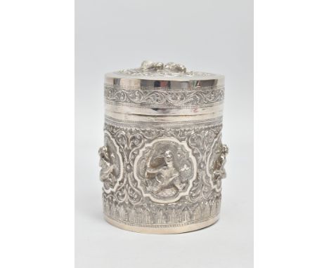 A WHITE METAL POT, embossed with south Asian artwork, the pot with a removable lid depicts two boys possibly praying with fol