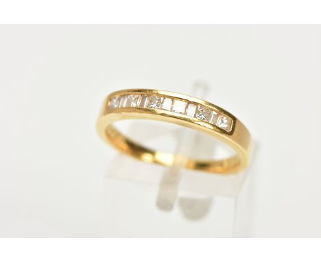 AN 18CT GOLD DIAMOND HALF ETERNITY RING, designed with a row of channel set, princess cut and baguette cut diamonds, stamped 