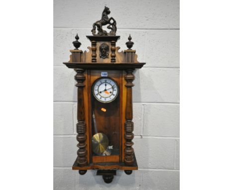 A LATE VICTORIAN GUSTAV BECKER WALNUT VIENNA WALL CLOCK, with ceramic horse pediment, winding key and pendulum, height 100cm 