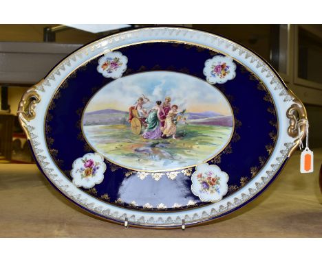 A ROYAL VIENNA PORCELAIN OVAL TRAY, depicting a scene of three ladies and cupid in a landscape within a dark blue and floral 