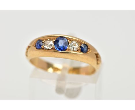 A LATE 19TH CENTURY SAPPHIRE AND DIAMOND RING, designed with three circular cut blue sapphires, interspaced with two old cut 