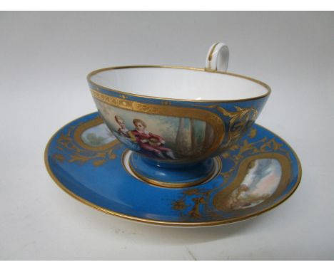 A Sevres Chateaux de Dreux large cup and saucer, the cup decorated with a vignette of a boy and girl, he playing a lute, the 