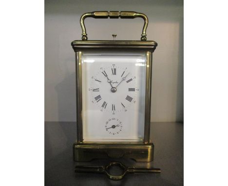 A 20th century brass repeater alarm, carriage clock, the white enamel dial signed Angelus, having Roman numerals and alarm di