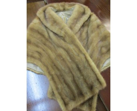 A light brown vintage musquash wrap 