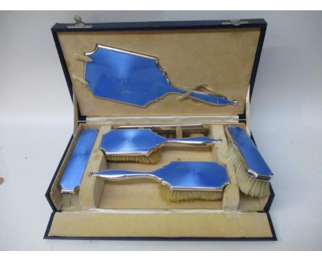 A 1930s blue enamelled, engine turned silver, five piece dressing table set by William Comyns &amp; Sons Ltd London 1936 comp