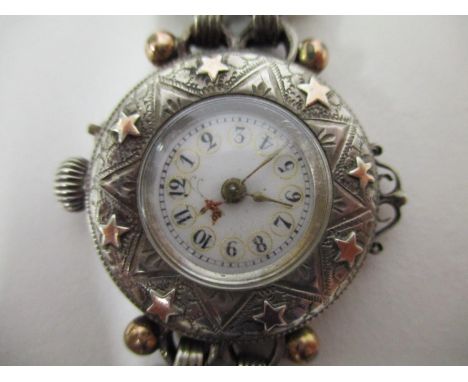 A ladies white and gold coloured metal wristwatch having an engraved case, chain link bracelet adapted from a Fob watch, circ