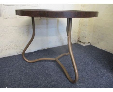 A vintage brown Bakelite topped occasional table on brown enamelled, tubular metal legs, 19" h, 23 1/2"dia 