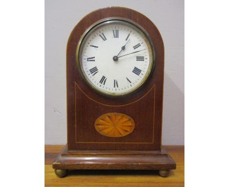 An Edwardian mahogany 8 day, arched topped mantle clock having a white enamel dial with Roman numerals, inlaid decoration and
