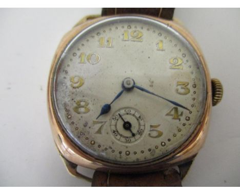 A gents 9k gold cased vintage wristwatch with 15 jewelled Swiss movement, having a silvered dial with Arabic numerals and sub