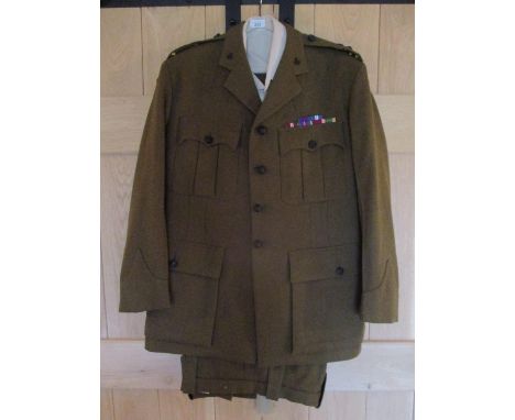 An Army ACF Rifles Training Officer's uniform with medal ribbons for campaign medals and various ACF badges to the epaulettes