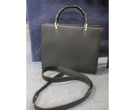 A Gucci black leather handbag with bamboo handles, serial number 002 1010 3754, with detachable shoulder strap, in good condi