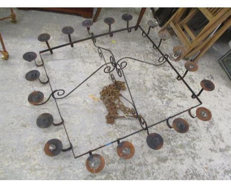 A large wrought iron ceiling hanging twenty branch light 