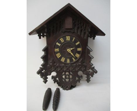 An early 20th century two weight, Black Forest oak cuckoo clock, chalet case with carved decoration, no pendulum, 16" h 