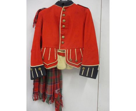 A Kings Regiment red regimental jacket with tartan sash, having Kings Regiment buttons (several missing) 