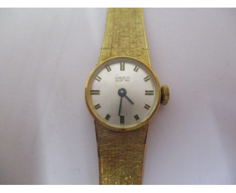 An Orma ladies 14ct gold manual wind wristwatch having a silvered dial with baton markers, blued hands and a flexible 14ct br
