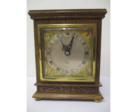 An Elliott of London oak eight day mantle clock, retailed by Aspreys, having a square silvered dial, cast brass spandrels and