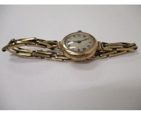 A ladies 9ct gold wristwatch with an engine dial and Roman numerals, on an expandable bracelet, 21.8g, total 