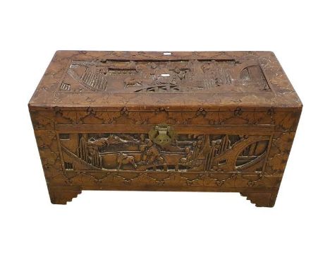 Chinese Carved Camphor Wood Chest, top decorated with figures on bridge, buildings to distance, leaf border, on staged bracke