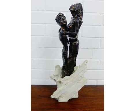 A contemporary bronze resin sculpture of 'The Lovers' on a stone plinth base, 54cm high