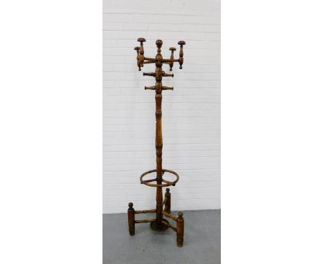 A turned fruitwood hat, coat  and stick coat stand 184cm high 