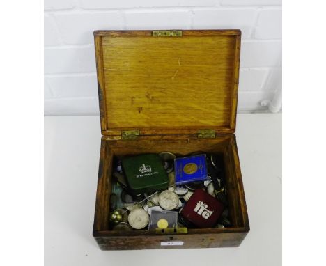 A vintage wooden box containing a collection of replica and other coins to include British and European pre-decimal and later