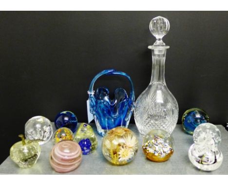 A collection of paperweights to include Caithness and Mdina, together with a decanter and stopper and a blue art glass basket