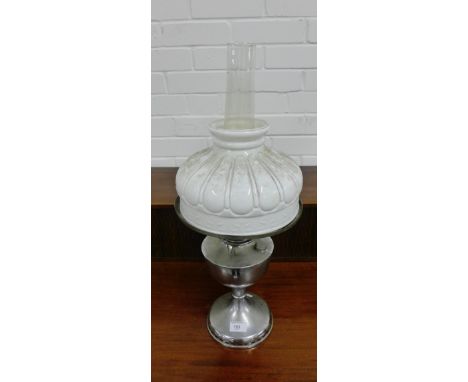A paraffin lamp with an opaque white glass shade