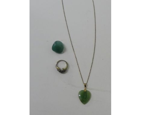 A 14 carat gold mounted heart shaped jade pendant on a 14 carat gold chain, together with a green jade pebble and costume jew