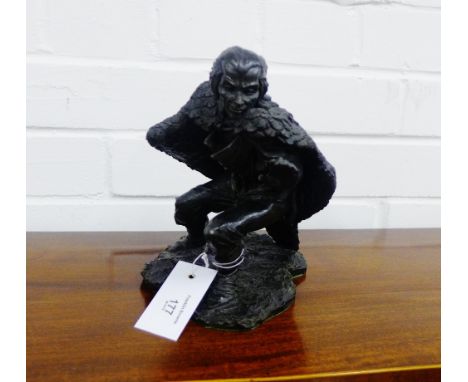 A resin figure of a male dressed in an eagle cloak, 20cm high 