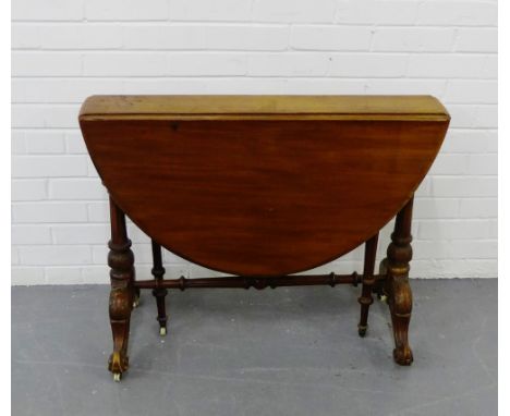 A mahogany drop leaf table with column pillared legs and stretcher on C scrolled feet with ceramic coasters, 70 x 90cm